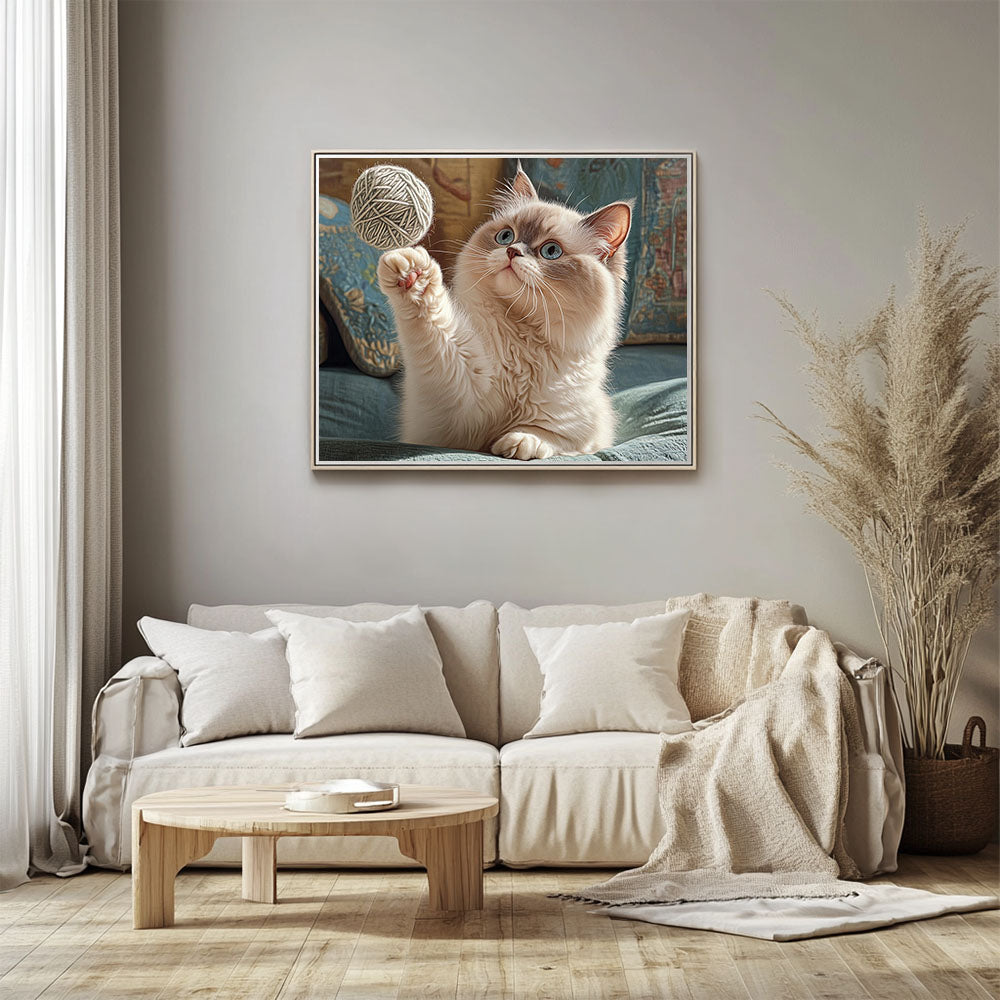 Ragdoll cat grabs a ball